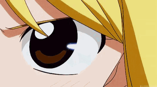a close up of a girl 's eye with a yellow hair and a black pupil .