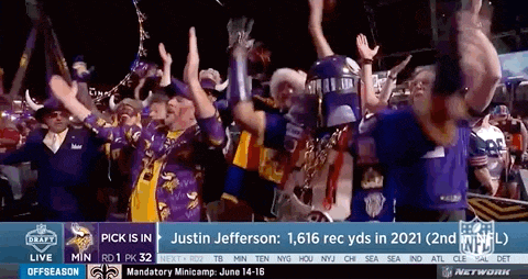 a group of people are standing in front of a screen that says justin jefferson