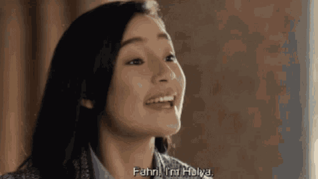 a woman is smiling with the words fahri i 'm holya behind her