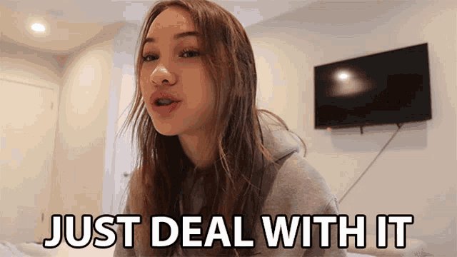 a girl says just deal with it in front of a television
