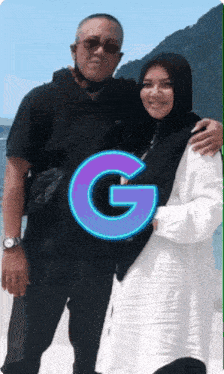 a man and a woman are posing for a picture with the letter g above them