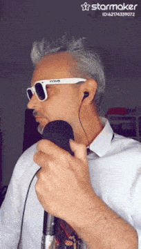a man singing into a microphone with a starmaker watermark