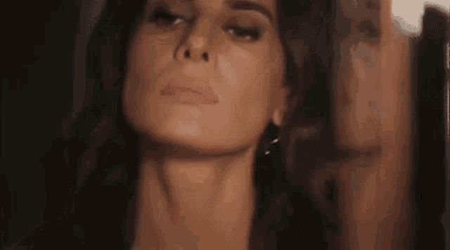 a close up of a woman 's face with her reflection in a mirror .