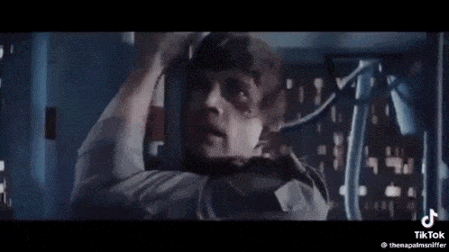 a man with a mask on his face is saying `` fuck you mean nuh uh schally '' .