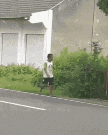 a man is walking along the side of a road