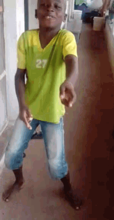 a young boy in a yellow shirt with the number 27 on it