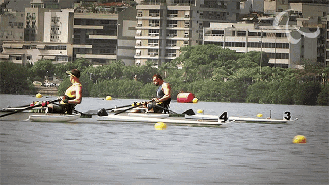 two men are rowing a boat with the number 4 on the side