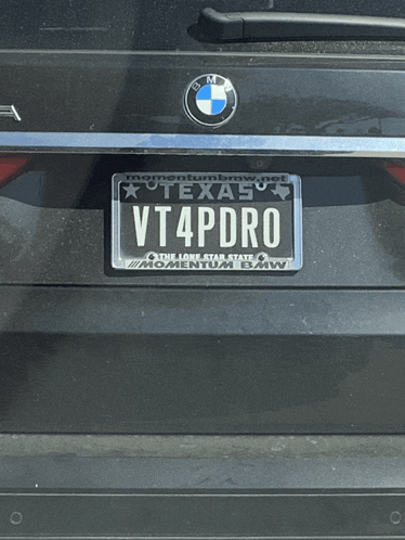 a black bmw with a texas license plate that reads vt4pdro