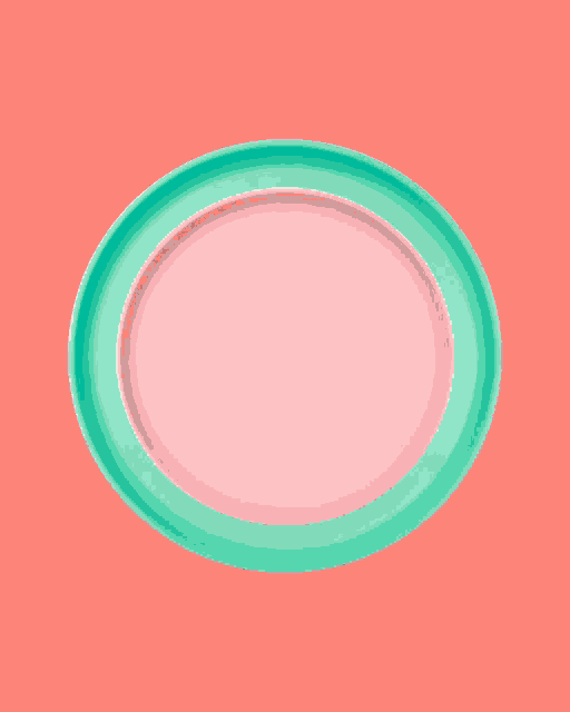 a white plate with a green border on a blue surface