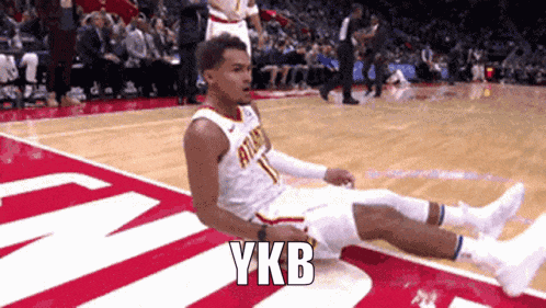 a basketball player is laying on the floor with ykb written on the side