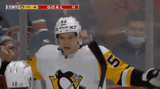 a hockey player in a pittsburgh penguins uniform celebrates a goal