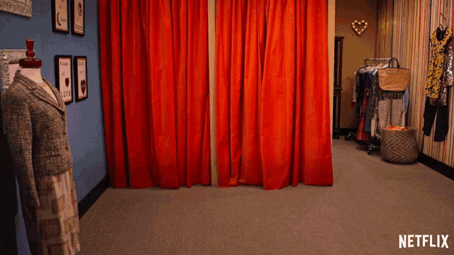 a dressing room with red curtains and a netflix logo on the bottom