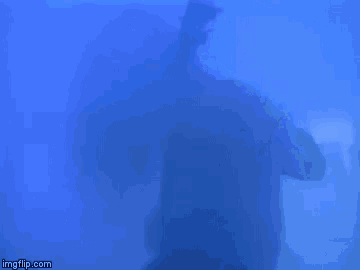 a silhouette of a person holding a microphone with imgflip.com in the corner