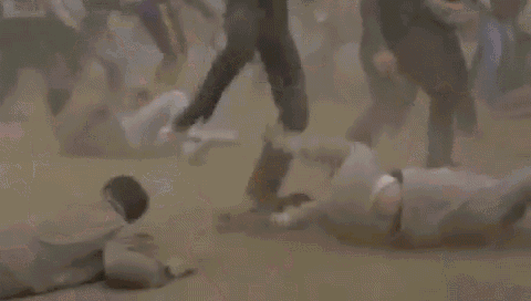 a blurry picture of a crowd of people running in the dirt .