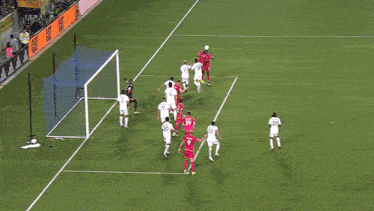 a group of soccer players are playing on a field and one of them has the number 20 on his shirt