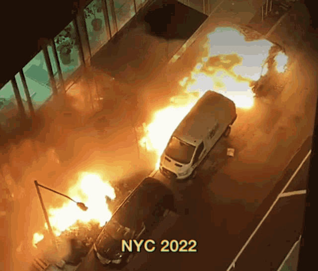 a white van is on fire and the year 2022 is on the bottom right