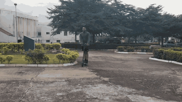 a man is riding a scooter down a street