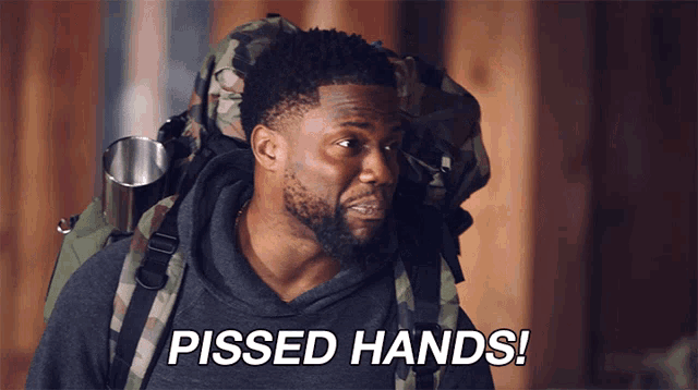 a man with a backpack on his back says pissed hands