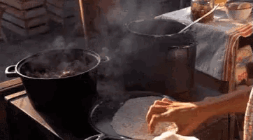 a person is making a tortilla on a stove top