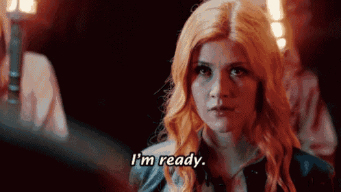 a woman with red hair says i 'm ready in a dark room .
