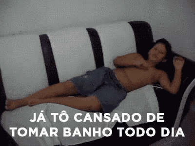 a shirtless man is laying on a black and white couch .