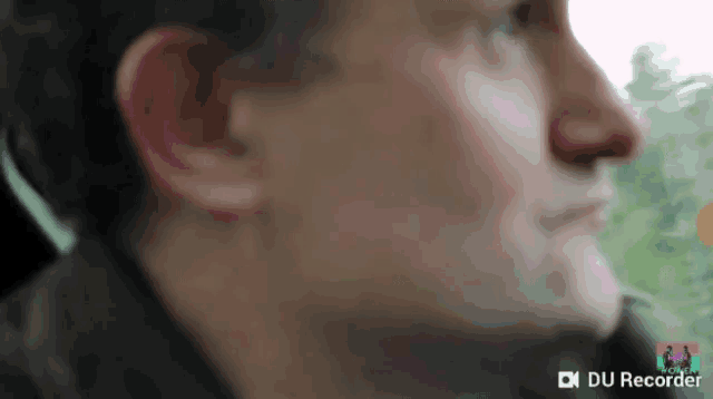 a close up of a man 's face with the words du recorder visible