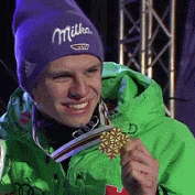 a man wearing a milka hat is holding a medal