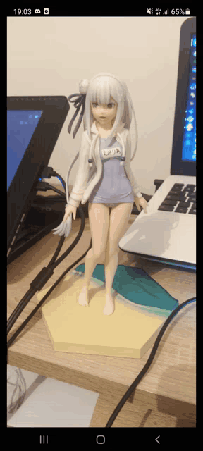 a statue of a girl with the number 65 on her shirt