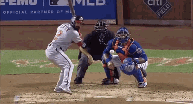 a baseball player with the number 3 on his jersey swings at a pitch
