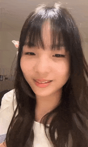 a close up of a woman with long hair and bangs