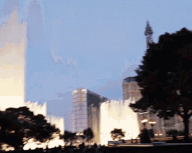 a blurry picture of a fountain in front of a building that has the word mgm on it
