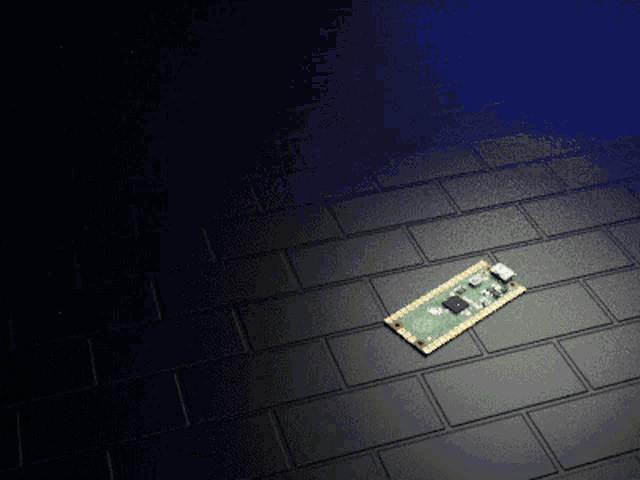 a motherboard is laying on a brick floor