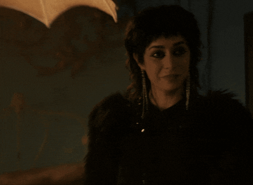 a woman in a black fur coat is smiling