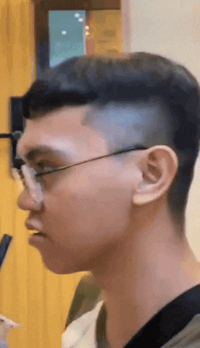 a close up of a man 's face with glasses and a shaved head