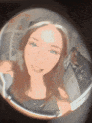 a woman is taking a picture of herself in a fisheye lens