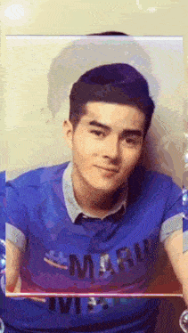 a young man wearing a blue shirt that says maru