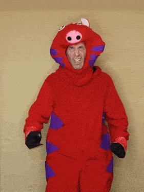 a man in a red pig costume with purple ears