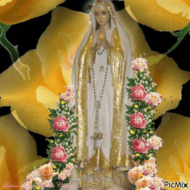 a statue of the virgin mary is surrounded by pink roses