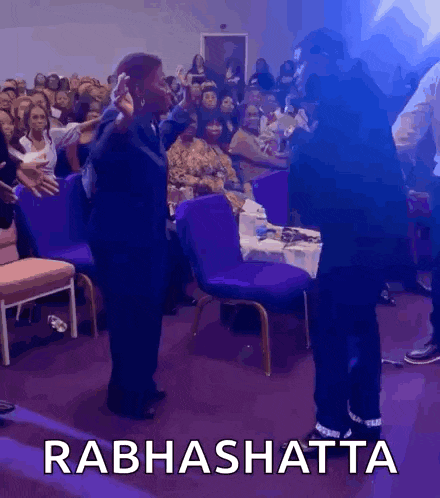 two people are dancing in front of a crowd and the word rabhashatta is on the bottom of the image