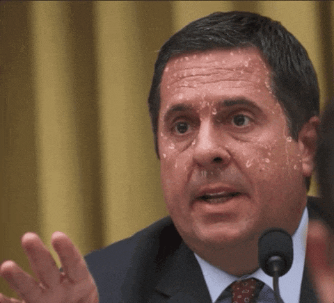 a man in a suit and tie with sweat coming out of his face