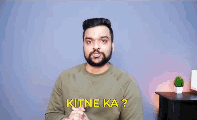 a man with a beard says kitne ka in yellow letters