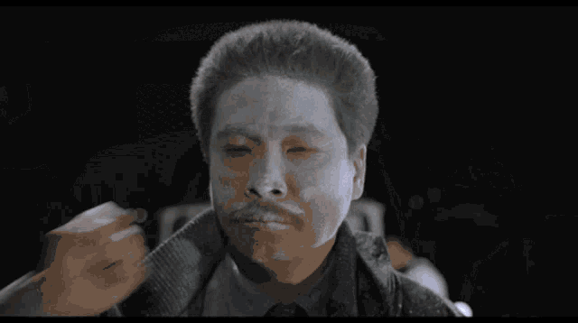 a man with smoke coming out of his hair looks at the camera