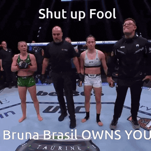 a group of people standing in a boxing ring with the words shut up fool bruna brasil owns you