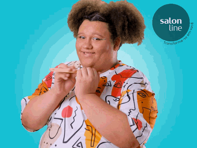 a woman with curly hair is smiling in front of a blue background with a salon line logo