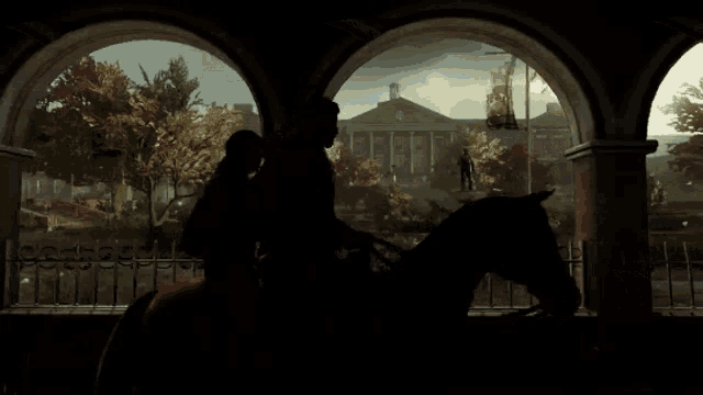 a couple riding a horse in front of a building