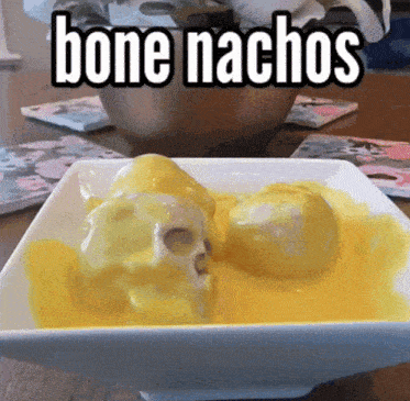 a bowl of bone nachos with a skull in the cheese