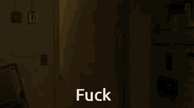 a dark room with the word fuck written on the bottom