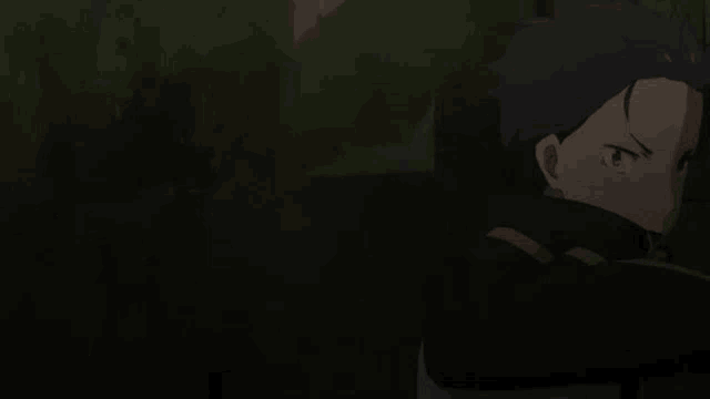 a young boy is standing in a dark room with a shadow on his head .
