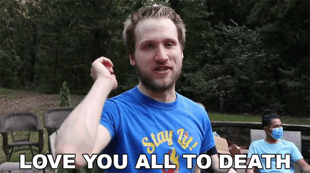 a man wearing a blue shirt that says " stay lit "