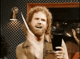 a man with a beard is holding a pair of scissors and a drum stick